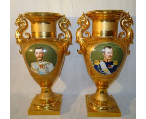 A pair of large impressive Continental porcelain gilt vases: The elaborate gilt bodies reserved with oval panels, painted wit