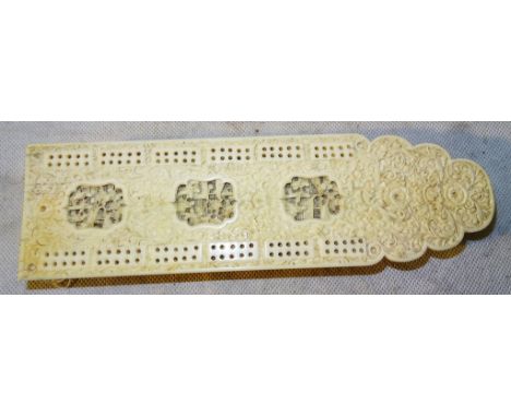 A Canton ivory cribbage board

19th century

Decorated with three cartouches with figures on terraces engaged in leisurely ac