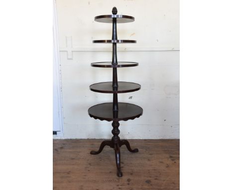 A Victorian mahogany five tier circular whatnot on a gadrooned turned stem, tripod legs and pad feet, the largest circular tr