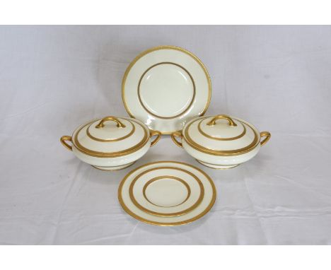 A Royal Doulton dinner service with gilt decorated borders comprising six dinner plates, nine dessert plates, three shallow s