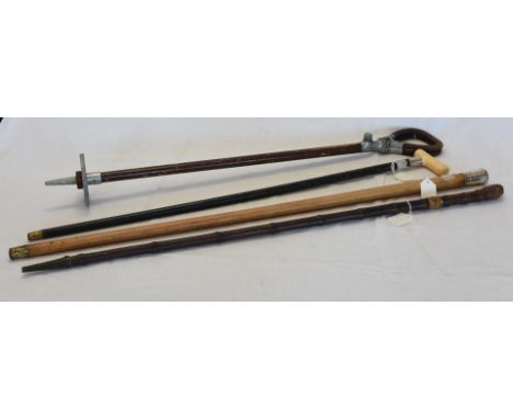 A silver mounted Malacca cane.  London 1888.  A shooting stick.  A white metal mounted walking stick and a bamboo sword stick