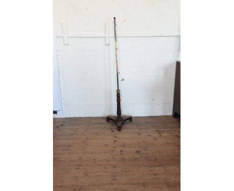 A Victorian brass and mahogany pole screen on turned supports, tripod plateau base and bun feet.  