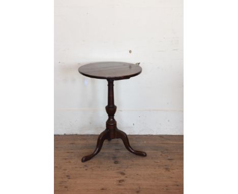 A George III oak circular tripod table on turned stem, tripod legs and pad feet.  18½ins wide.  