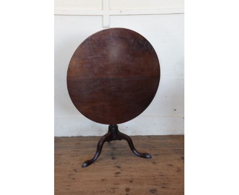 A Georgian mahogany tripod table with circular folding top, turned stem on tripod legs and pad feet.  33¼ins wide.  