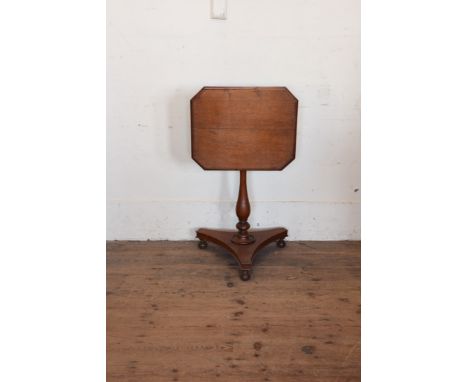 A 19th century oak rectangular tilt top table on turned vase shaped stem, tripod plateau base and bun feet.  19ins wide.  