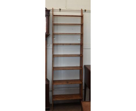 A pine open shelf with eight graduated shelves.  24¼ins wide.  