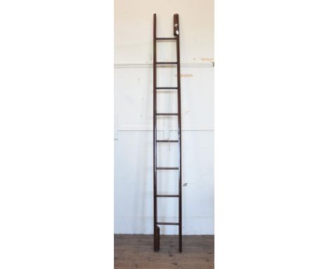 A mid 19th century folding library pole ladder with central push-button mechanism, stamped ‘Taylors Patent’ and with eight ru