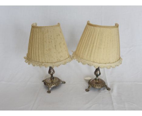 A pair of silver plated table lamps with tapering stems, circular beaded bases and tripod paw feet.  