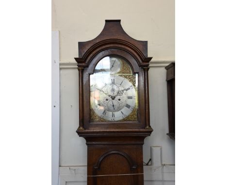 An 18th century oak cased longcase clock, the hood with pagoda arched top above an arched glazed door flanked by half pilaste