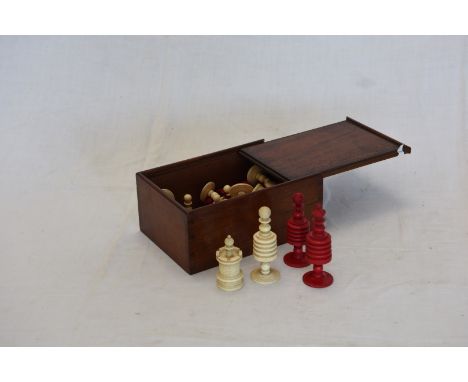 A 19th century turned ivory stained chess set in a mahogany box with sliding lid.  