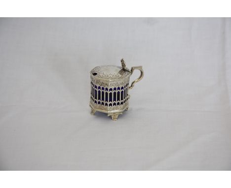 A Victorian silver mustard pot of octagonal form with pierced fleur de lys finial, angular loop handle and rococo scroll engr