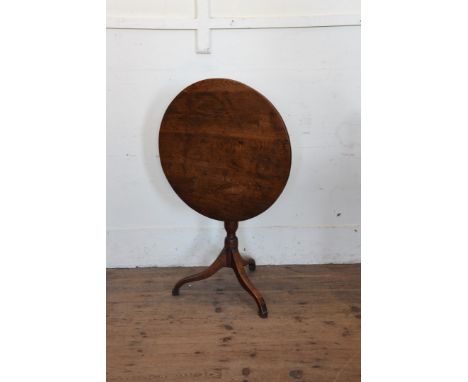 An early 19th century circular top tripod table on a turned stem, tripod legs and block feet.  26½ins diameter. 