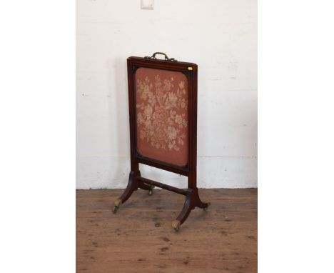 A Victorian mahogany firescreen with pull-up top section and fabric panel on reeded out-splayed legs, turned stretcher and br