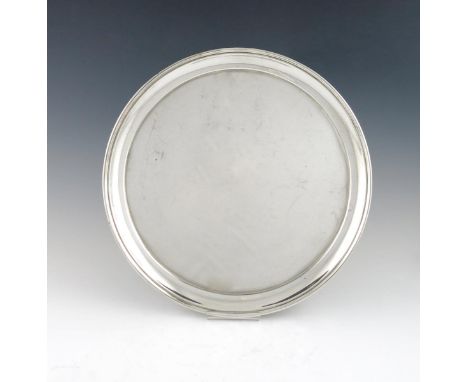 A silver salver, by Thomas Bradbury and Sons, Sheffield 1936, circular form, moulded border, on three bracket feet, diameter 