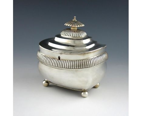 λA George III silver tea caddy, by Crispin Fuller, London 1809, oblong bellied form, fluted girdle, flush hinged raised cover