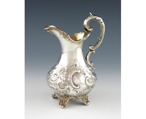 A Victorian silver cream jug, by A and J Savory, London 1852, baluster form, embossed foliate and scroll decoration, leaf cap