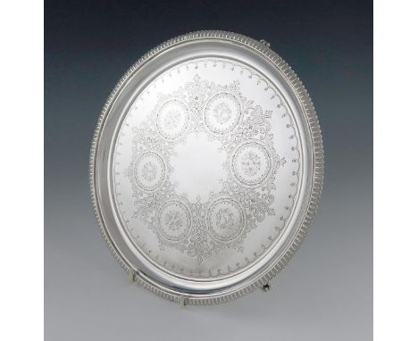 A Victorian silver salver, by Martin, Hall and Company, London 1873, circular form, gadroon border, engraved decoration, on t