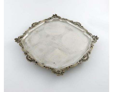 A 19th century Dutch silver salver, with earlier pseudo marks, shaped square form, shell and scroll border, on four foliate b