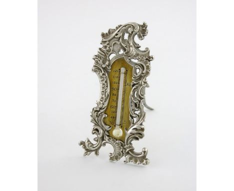 A Victorian silver desk thermometer, by Deakin and Francis, Birmingham 1894, shaped upright rectangular form, pierced foliate