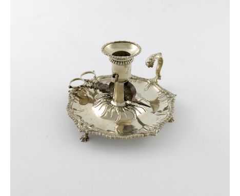 A George III silver chamber stick, by Ebenezer Coker, London 1772, circular form, gadroon and scroll border, on three webbed 