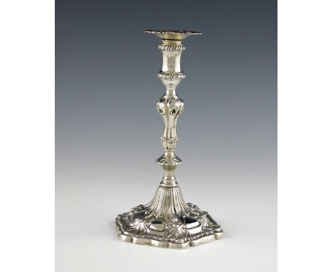 A George III cast silver taper stick, by Ebenezer Coker, London 1771, baluster stem, shell shoulders, spool-shaped capital wi