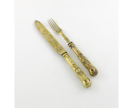 A Victorian silver-gilt private-die bread knife and fork, the handles by Robert Garrard, London 1846, the blade and tines by 