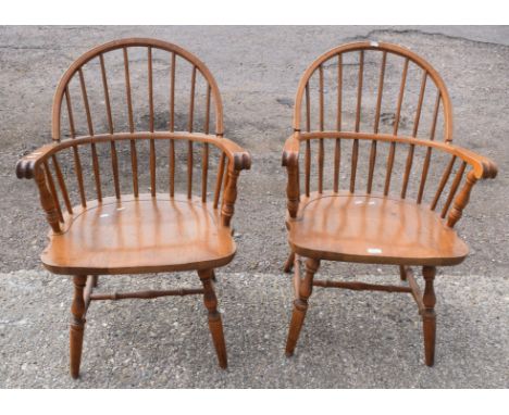 Pair of light oak stick back solid seat armchairs