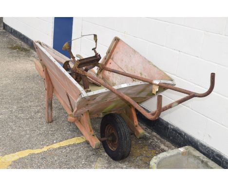 Large vintage wheelbarrow with metal bound rim, together with a vintage hoe, 90cm wide
