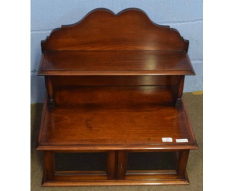 Mahogany table top cabinet, arched pediment and shelf over a glazed compartments, 62cm wide