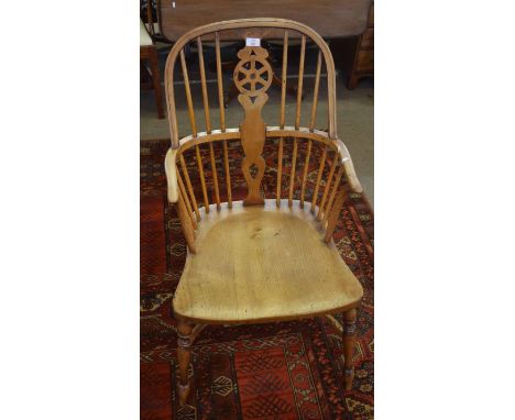 19th century yew topped stick and wheel back armchair with solid seat, ring turned splayed supports joined by a crinoline str