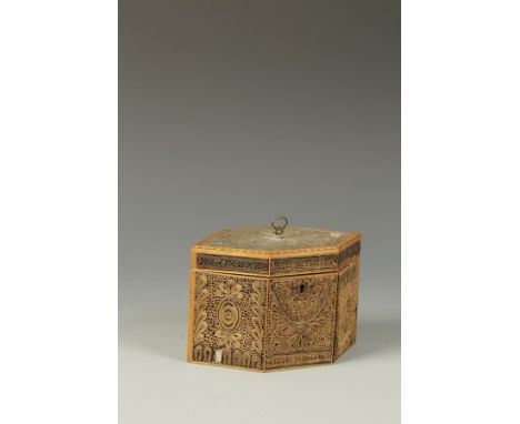 A GEORGE III SCROLLED PAPERWORK TEA CADDY with an hexagonal frame, all over mounted with scrolled paper panels, the interior 