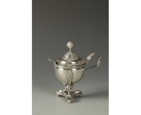 A DUTCH MUSTARD POT of circular tapering form with scroll handle and ball finial, on a triform base, with ball feet, gilt int