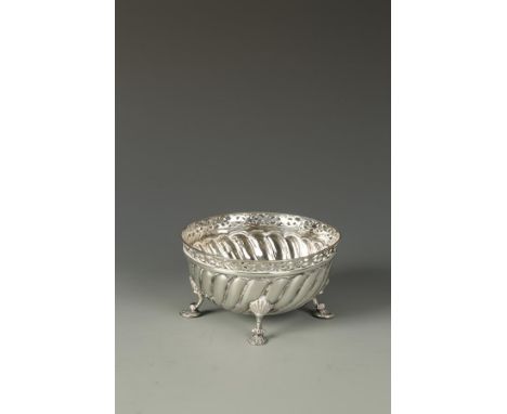 A VICTORIAN SUGAR BOWL of circular form, with pierced border and swirl fluted body, on shell capped feet, by James Wakeley & 