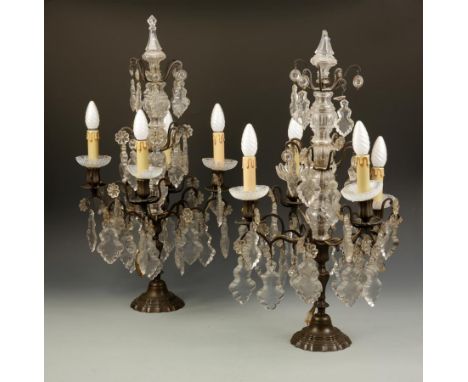 A PAIR OF CRYSTAL TABLE CANDELABRA, each with a central glass mounted column supporting two tiers of glass drops and a tier o