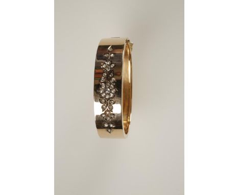 A FRENCH GOLD AND DIAMOND BANGLE, circa 1890, the plain bangle decorated with rose-cut diamonds in a floral motif to the fron