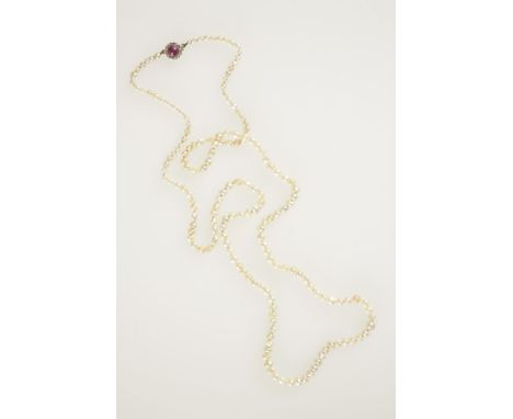 A SINGLE ROW NATURAL PEARL NECKLACE graduated from the front with a ruby and diamond cluster clasp. See illustration Accompan