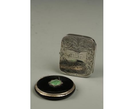 AN ART DECO STERLING SILVER AND BLACK ENAMELLED POWDER COMPACT inset to the cover with a circular green "jade" roundel, withi