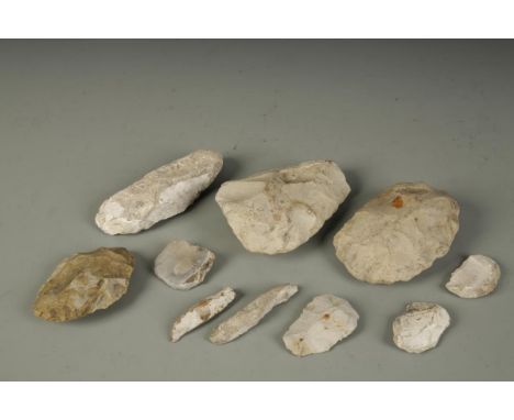 A COLLECTION OF TEN FLINT AXE HEADS of varying sizes, each labelled with the site of excavation and date, including 'Corfe 19