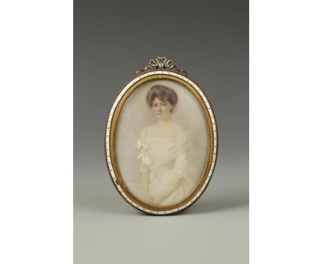 L. WOODRUFF A three-quarter length portrait miniature painted on ivory of a young lady in a white evening gown, with elbow-le