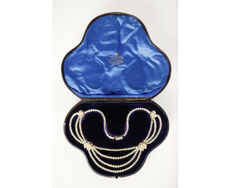 AN EDWARDIAN NECKLACE festooned with natural pearls interspersed with Georgian seed pearl clusters, in a fitted case. See ill