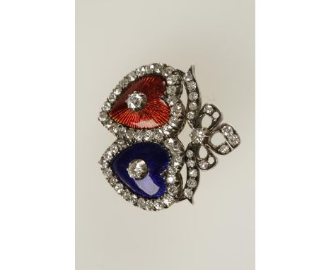 AN EDWARDIAN DIAMOND AND ENAMEL TWINNED HEART BROOCH decorated with blue and red guilloche enamel, claw-set with a circular-c
