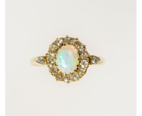 AN EDWARDIAN 18CT GOLD OPAL AND DIAMOND CLUSTER RING claw-set with a cabochon opal within a frame of cushion-shaped diamonds,