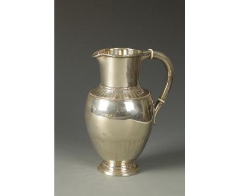 A DANISH PITCHER of tapering circular form with curved handle and part-fluted decoration, by C.F. Heise, Copenhagen, 1920, 7"