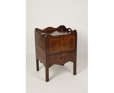 A GEORGE III MAHOGANY TRAY TOP COMMODE, the rectangular top with wavy border with pierced hand holds above a cupboard and pul