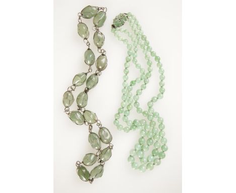 A TWO ROW JADE BEAD NECKLACE graduated from the front, beads measure 9.5mm to 5.5mm approximately, on a rectangular shaped pi