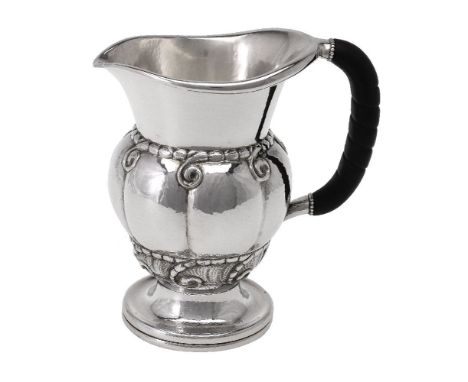 ϒGeorg Jensen, a Danish silver water jug or pitcher, post 1945 stamped marks, design no. 7, with an ebony handle, 20cm (8in) 