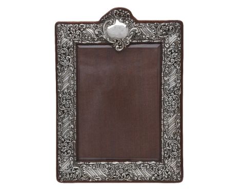 A late Victorian silver photograph frame by Henry Matthews, Birmingham 1900, rectangular with a vacant reserve above, embosse