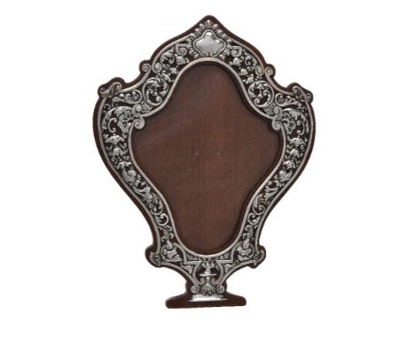 A late Victorian silver photograph frame by Samuel Jacob, London 1897, cartouche shaped, embossed with a vacant reserve and p