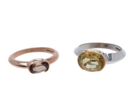 An andalusite ring, the oval cut andalusite in a part collet setting, stamped 375, finger size P, 3.4g gross; and a heliodor 