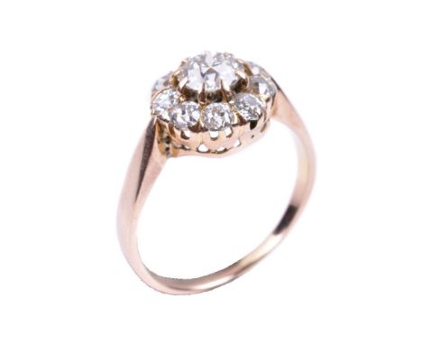 A diamond cluster ring, the central old brilliant cut diamond, estimated to weigh 0.60 carats, claw set within a surround of 